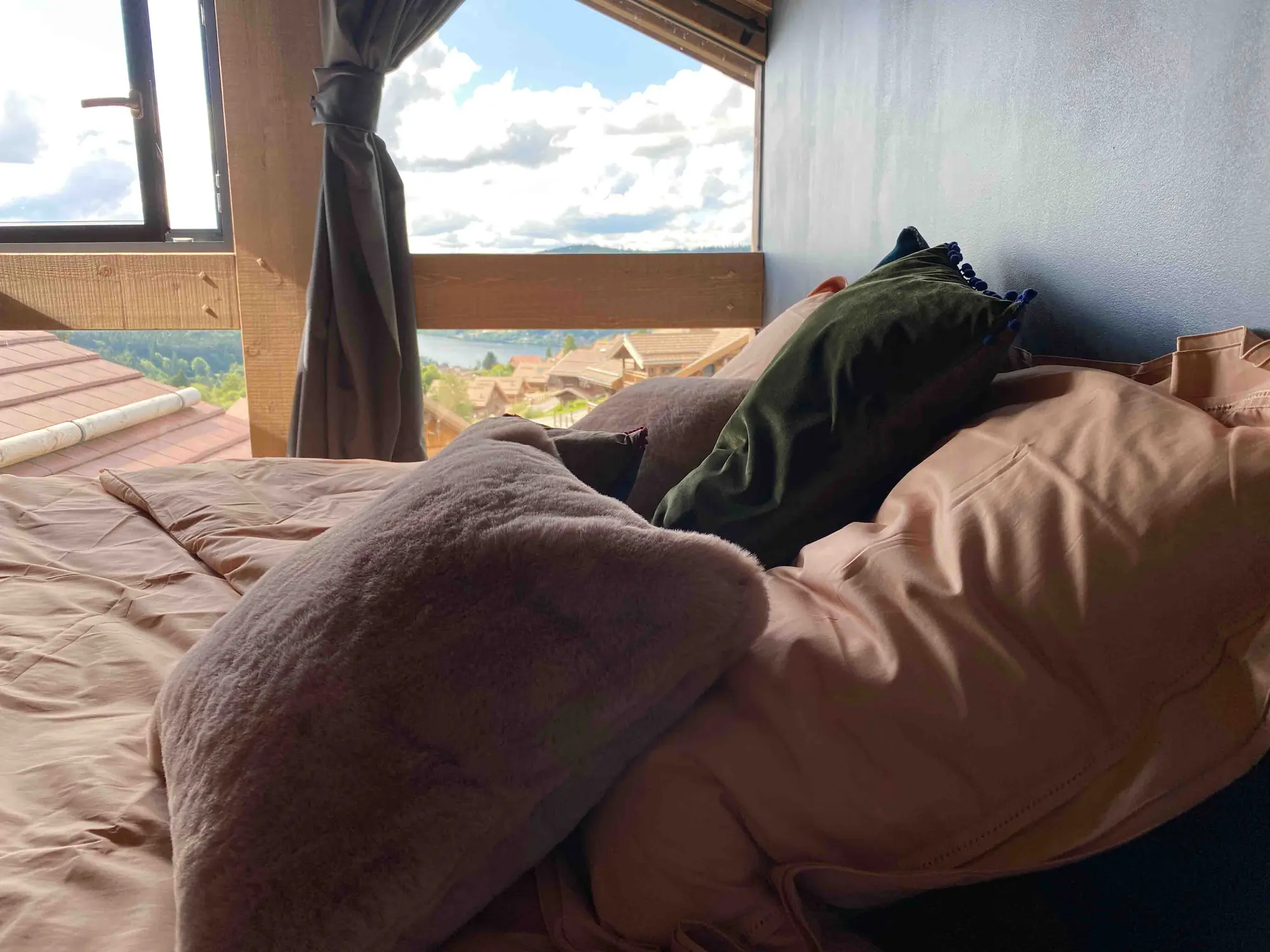 Bedroom under the eaves, looking out over Lake Gérardmer from the bed