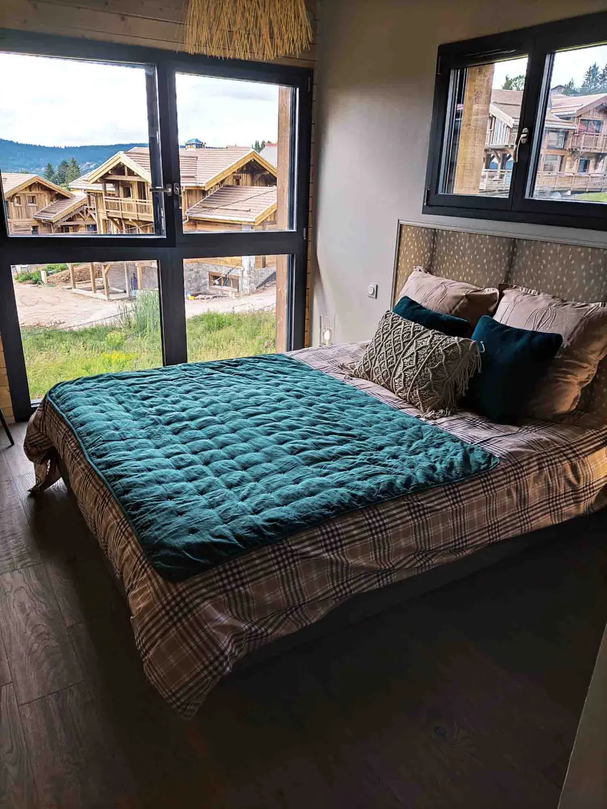 The chalet's teal bedroom with a large picture window