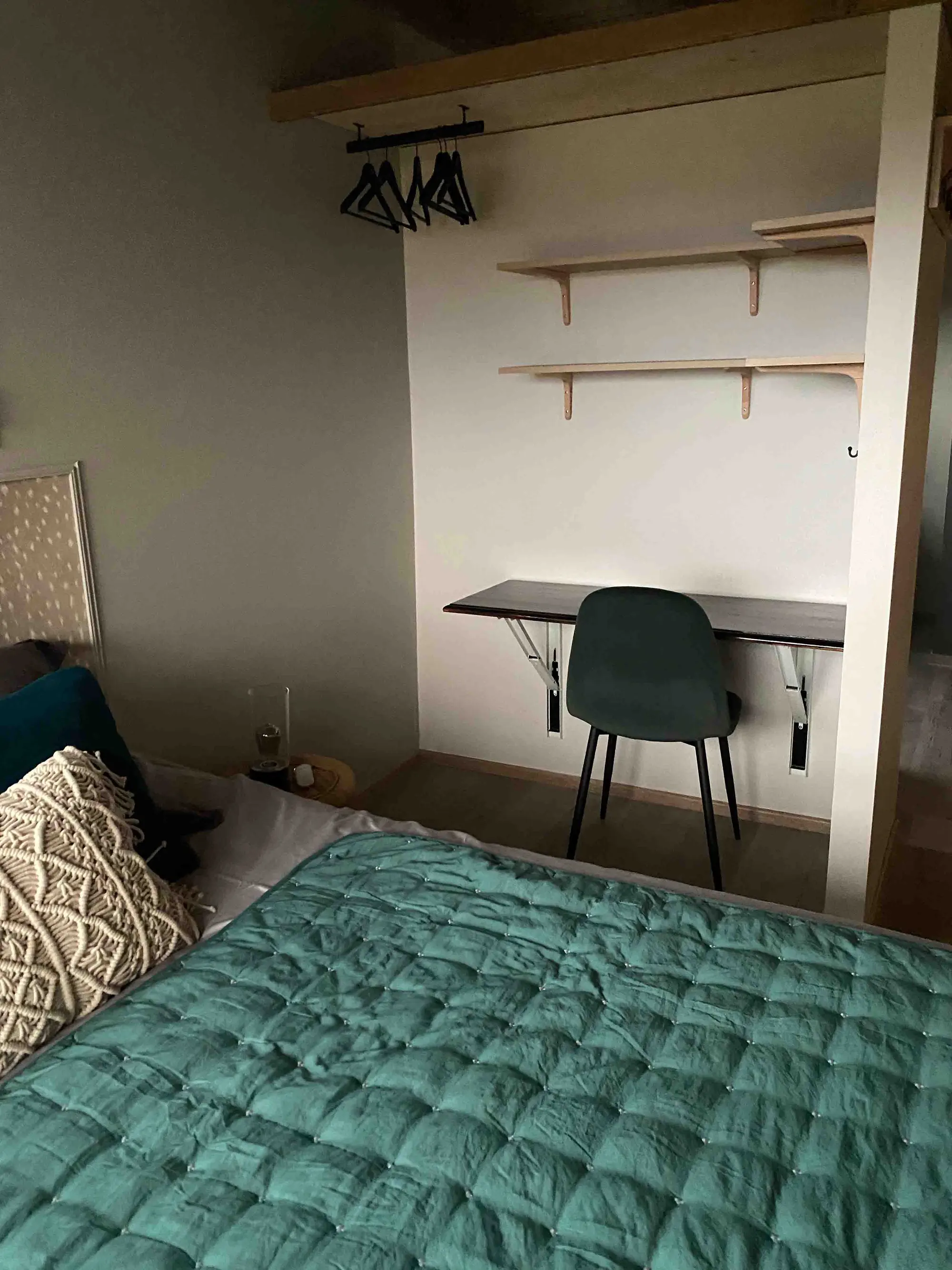 The chalet's teal bedroom with a large picture window
