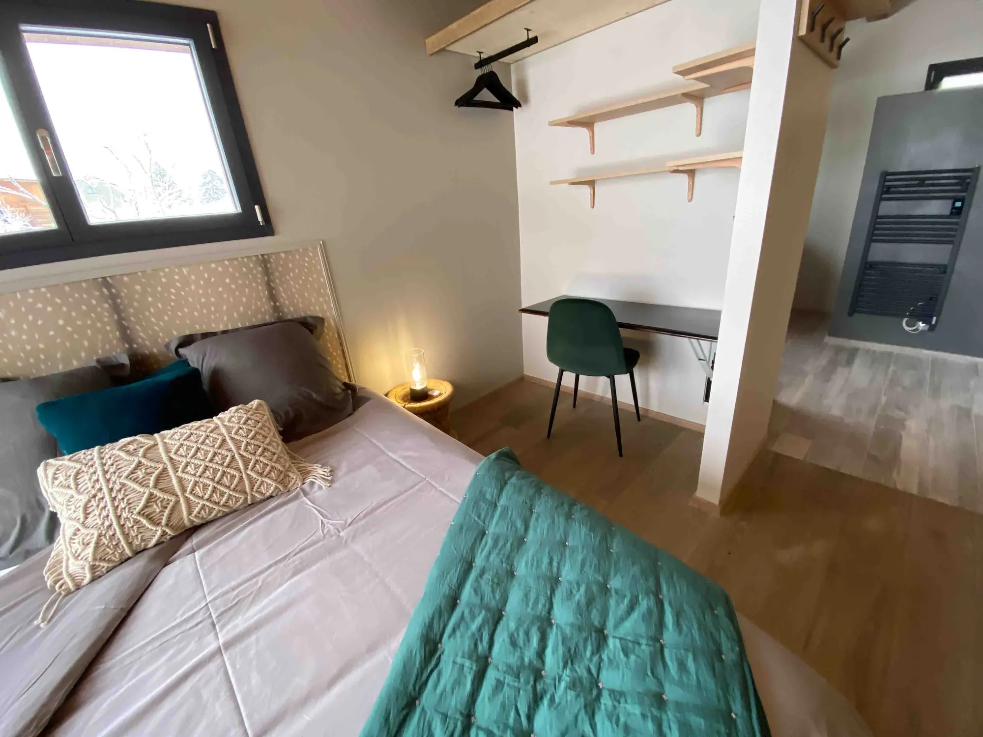 The chalet's teal bedroom with a large picture window