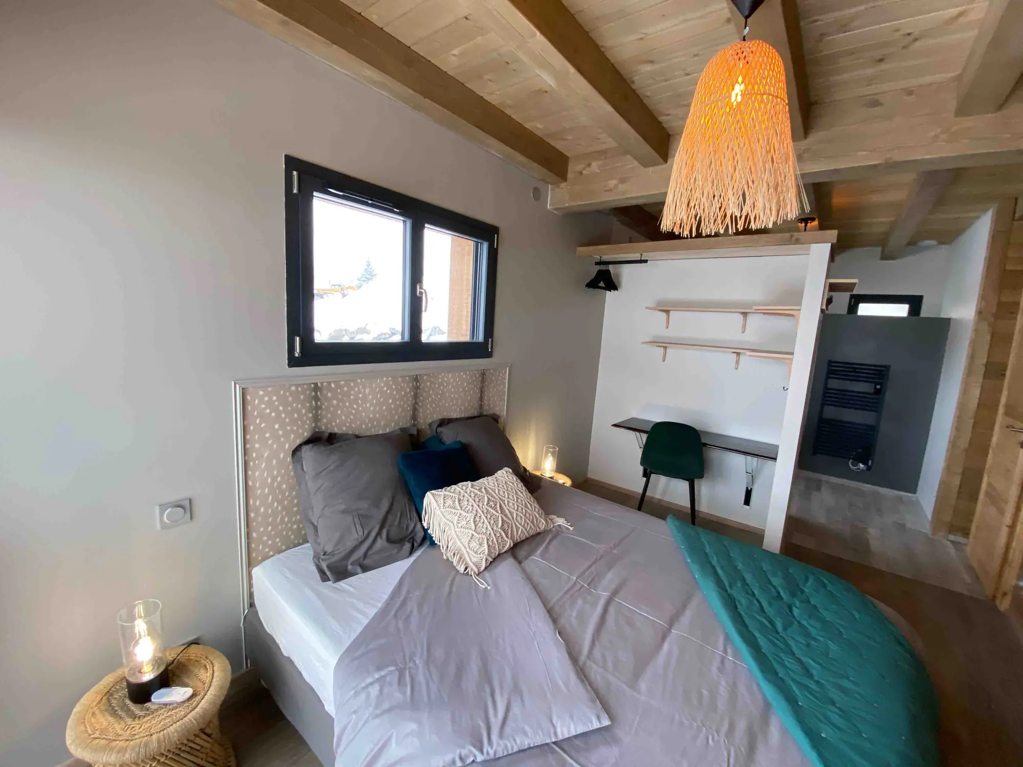The chalet's teal bedroom with a large picture window