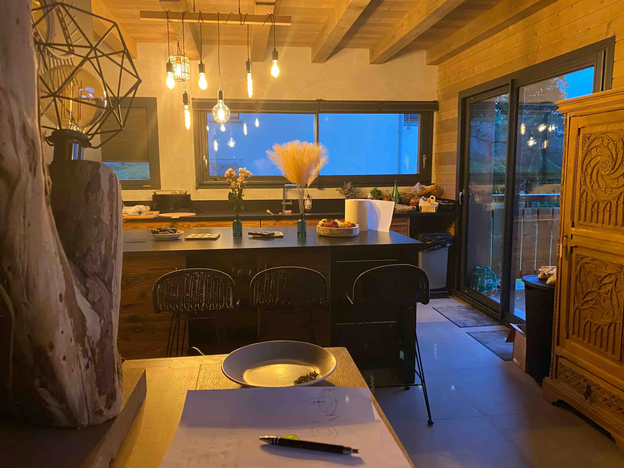 The chalet's open kitchen with central island and valley view
