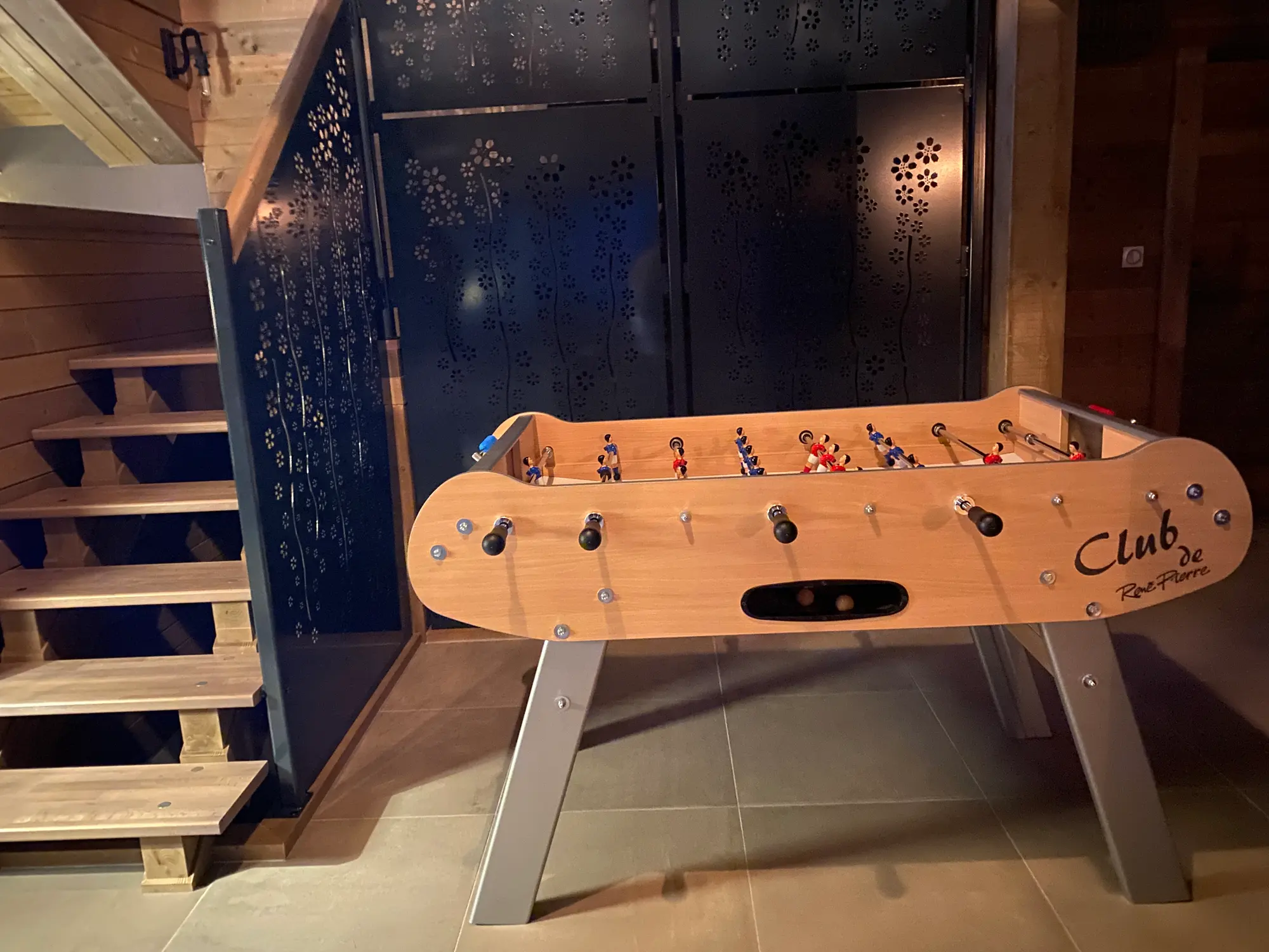 Chalet games area with foosball table and mezzanine