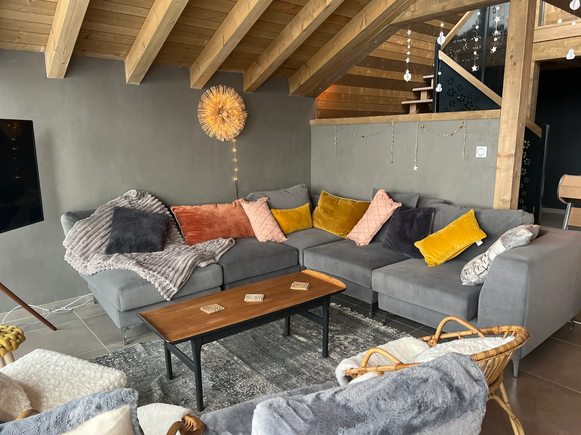 Chalet living room with corner sofa and exposed timber frame
