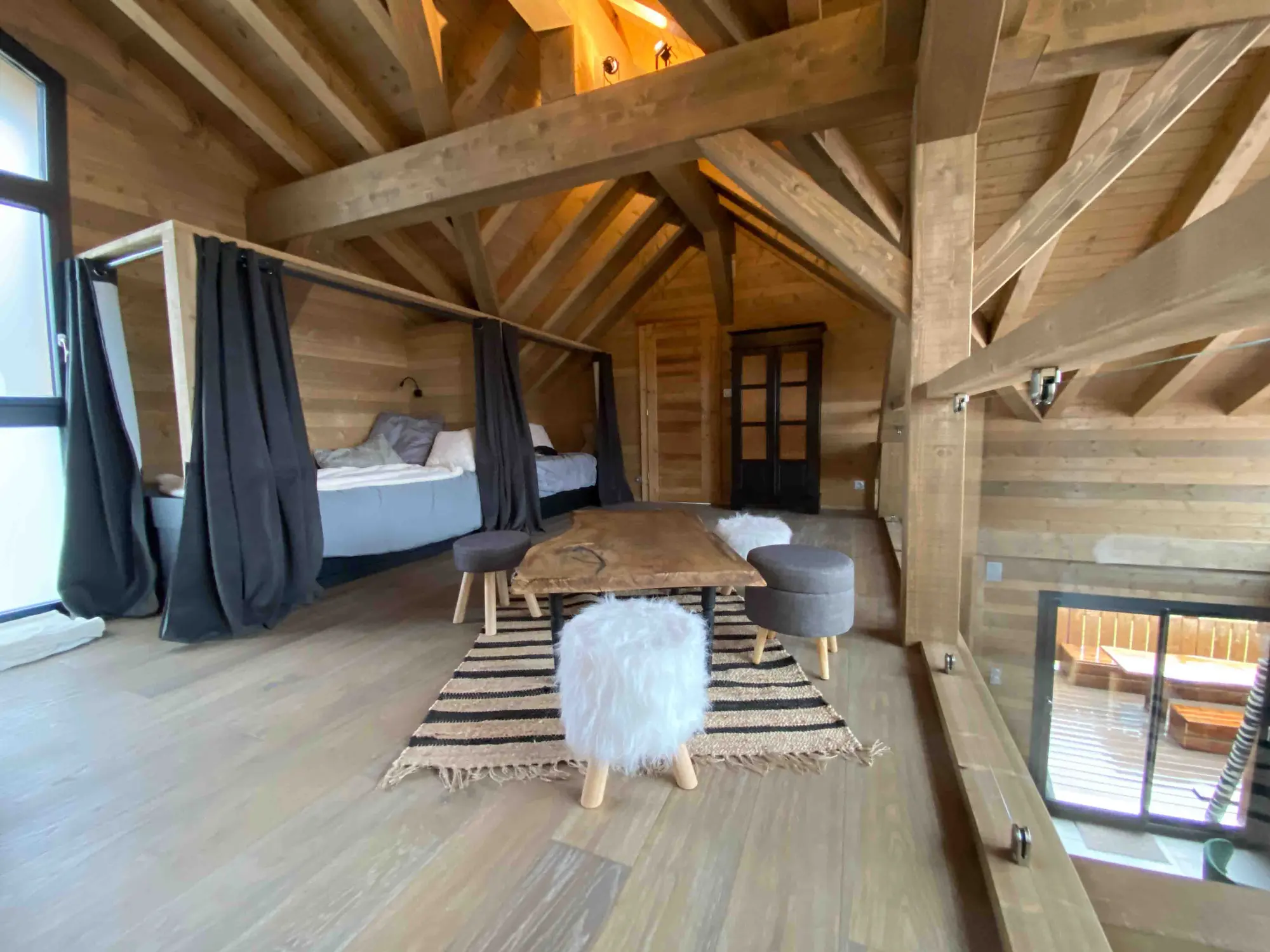 The chalet's mezzanine bedroom with curtains