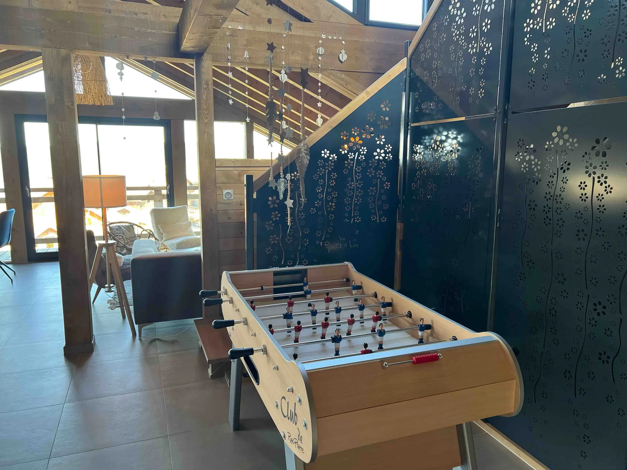 Chalet games area with foosball table and mezzanine