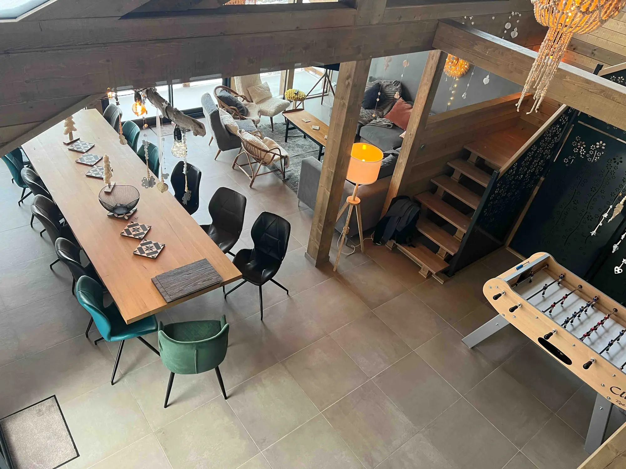The large wooden dining table, laid for thirteen guests