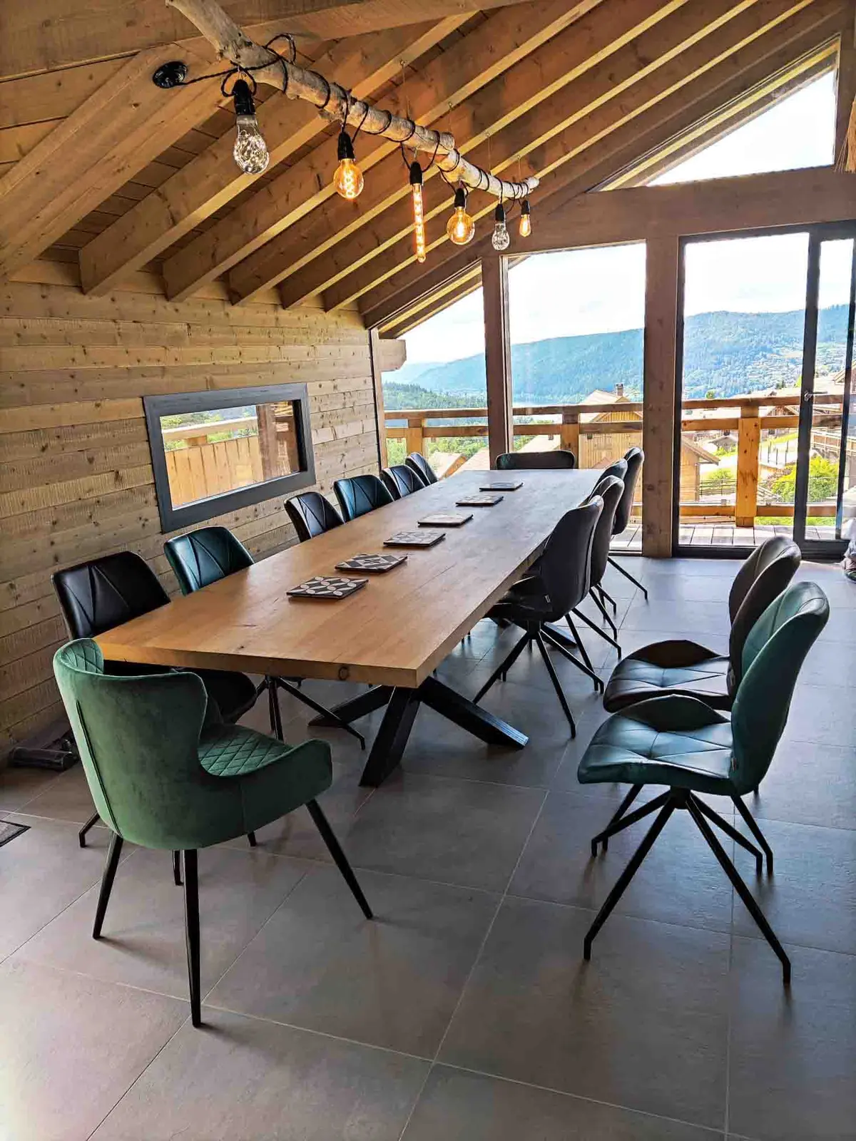 The large wooden dining table, laid for thirteen guests